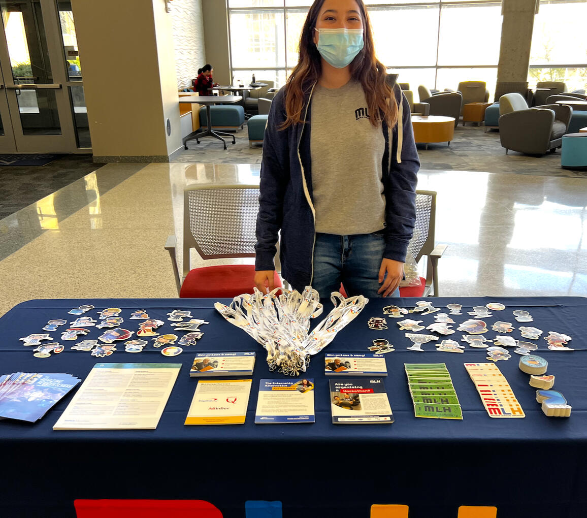 eliz at the mlh table for hackKU